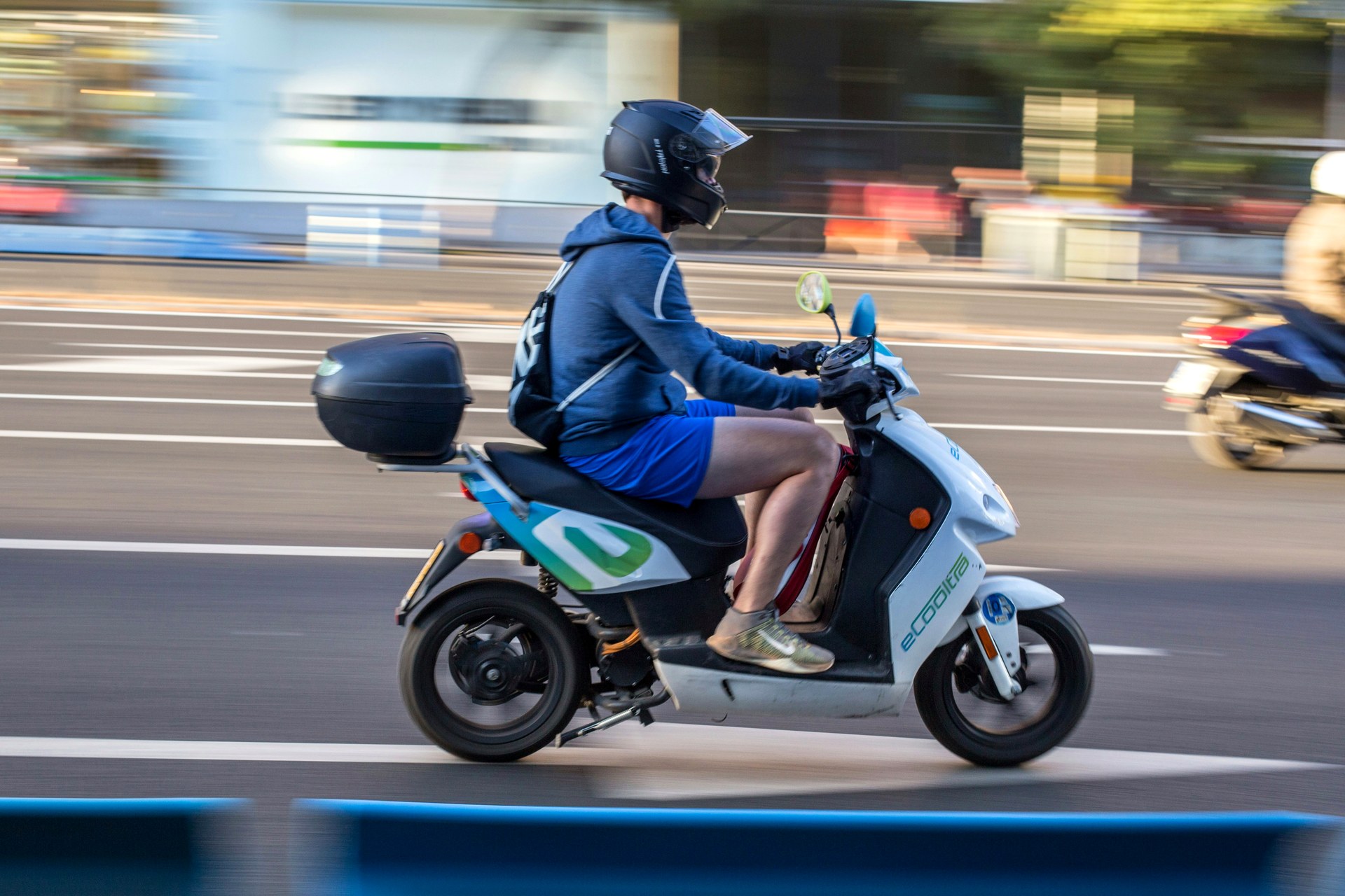 Electric scooter in motion on city road